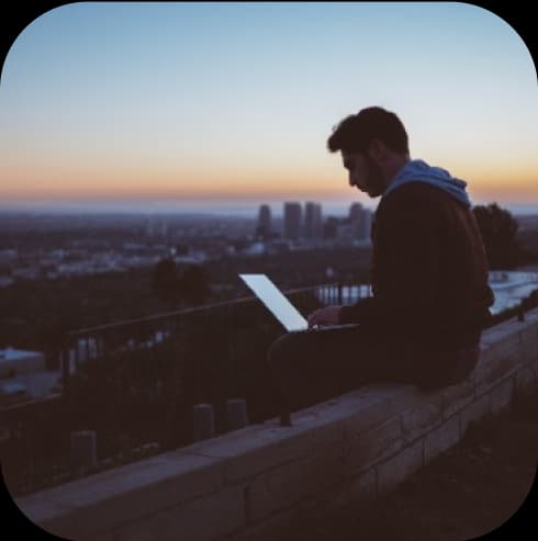 Person using laptop in balcony