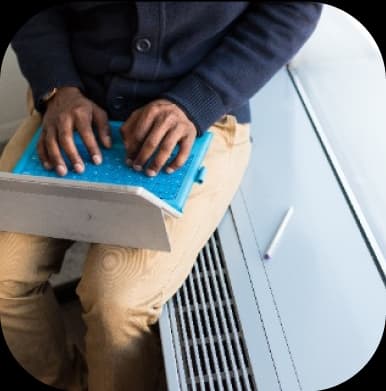 Person using laptop on subway